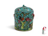 a blue container with a rooster and flowers on it