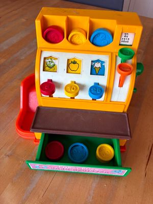 a toy cash register on a wooden table