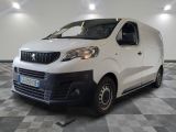 the white van is parked in a large room with a checkered floor
