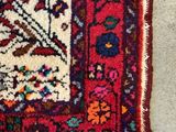 an oriental rug on the floor with a cat sleeping on top of it