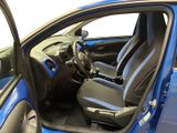 the interior of a blue car with the door open