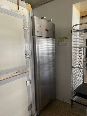 an image of a commercial kitchen with a stainless steel refrigerator