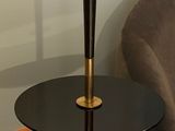 a lamp that is on a table next to a chair