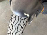 a close up of a motorcycle tire on a cement surface