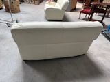 a white couch and a chair in a room