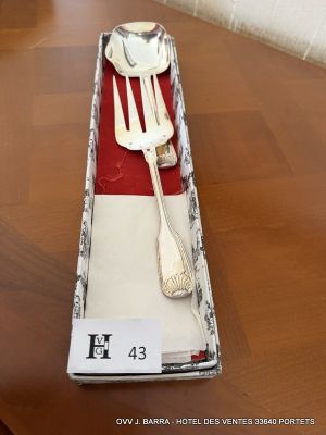 a fork and spoon in a box on a table