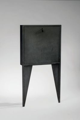 une petite table noire surmontée d'un tiroir