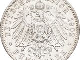 a close up of a silver coin with an eagle on it