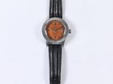 a close up of a watch on a white surface with a white background