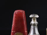 three bottles of perfume sitting on a table with a black background