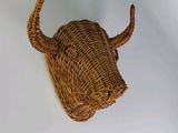 a wicker bull head mounted on the wall