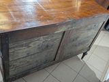 a very old wooden cabinet in the middle of a kitchen
