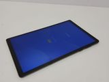 a close up of a tablet on a table with a blue screen