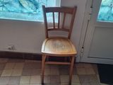 a cat that is sitting on the floor next to a chair