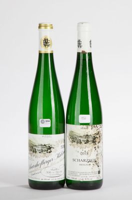 two bottles of wine sitting next to each other on a white surface