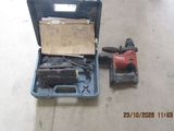 a box with a hammer and a drill on the floor
