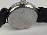 a close up of a watch on a white surface with a white background
