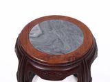 a small wooden table with a marble top on a white background