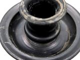 a black vase sitting on top of a white table