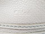 a close up of a stack of white leather