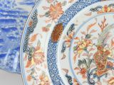 a blue and white plate with a floral design on it