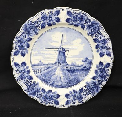 a blue and white plate with a windmill on it