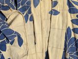 a close up of a blue and white shirt with blue flowers on it