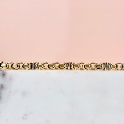 an image of a gold plated bracelet on a marble surface