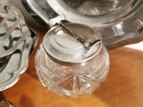 a silver plate with a spoon and a glass jar on a table