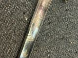 a very old sword that is laying on the ground