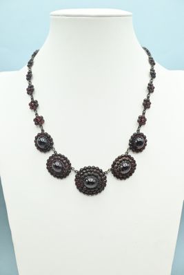 the necklace is made of glass beads and beads with black beads