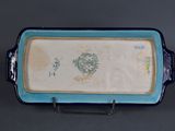 a blue and white tray with a stamp on it