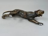 an image of a bronze statue of a cat on a white surface