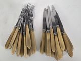 a lot of forks and knives on a white table