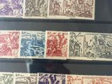 a collection of stamps from different countries on display in a glass case
