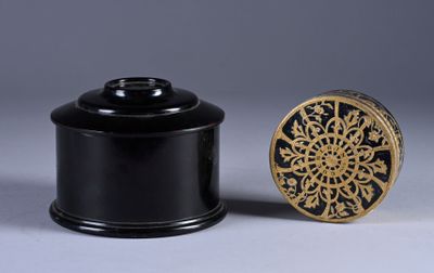 pair of black and gold boxes with a gold medallion on the lid