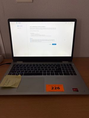 a laptop computer sitting on a desk with a price tag on it