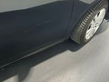 a car that is parked in the garage with its door open