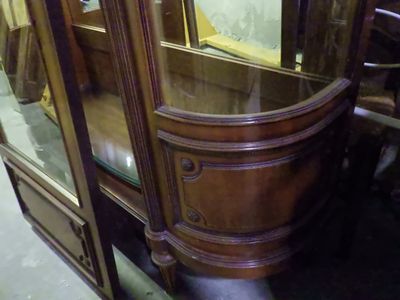 a glass display case with a mirror on top of it
