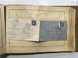 an open book with two stamps on it sitting on top of a table