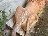 a statue of a lion that is sitting on a bench