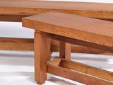 two wooden benches sitting next to each other on a white surface