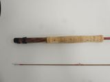 an image of a fishing rod and a fly rod on a white surface