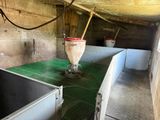 a room with two sinks and a bucket on the counter