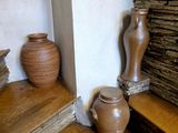 two vases sitting on the steps of a stone wall