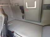 a small bed in the back of a train car