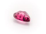 a close up of a pink diamond on a white surface