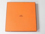 a box with an orange cover sitting on top of a white table