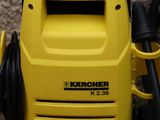 a yellow pressurer with a hose attached to it