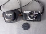 a camera and a lens on a table next to a camera case